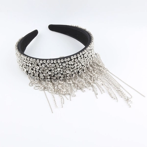 Detailed macro view of wide black headband with sparkling rhinestone tassel fringes