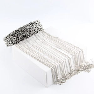 Close-up of luxury Baroque black choker featuring long sparkling rhinestone tassels