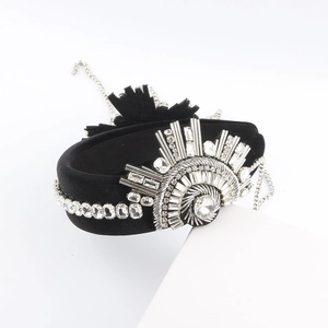 Detailed view of luxury black velvet headband with sparkling silver rhinestones and crystal fringe