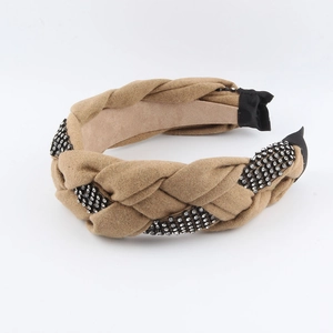 Close-up of camel braided fabric headband featuring sparkling rhinestone details