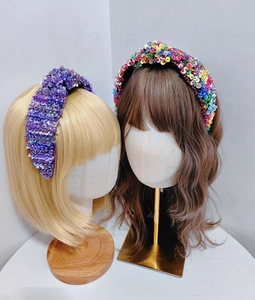 Detail of colorful and purple sequin headbands showing texture on display heads