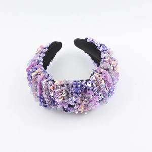 Close-up of wide purple sequined headband featuring detailed beads and shimmering crystals