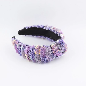Close-up of purple sequins headband with iridescent glitter and black fabric inner lining
