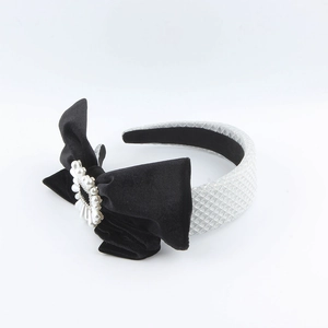 Elegant velvet bow headband with pearls and rhinestones on a textured silver band