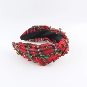 Detail of red and green plaid headband with embedded crystals in retro british style