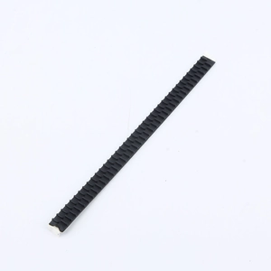 Close-up of black anti-slip hairband strip with fine teeth and adhesive backing