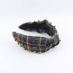 Detail view of retro plaid headband with hand-stitched red and green rhinestones