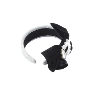 Elegant black velvet bow headband with central pearl flower and silver lattice textured base