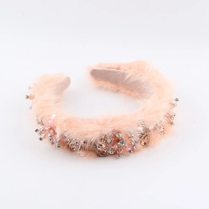 Close-up of pink baroque faux fur headband with luxury rhinestone and crystal bead accents
