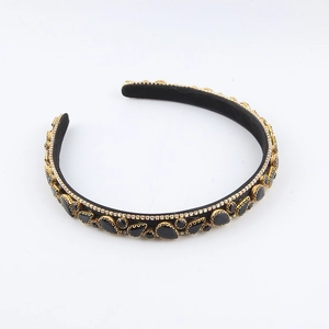 Close-up of black gemstones and rhinestones on the vintage gold baroque headband