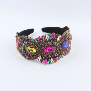 Detail of a luxury Baroque headband with multicolored rhinestones on black velvet