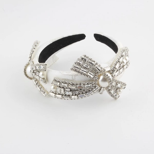 Elegant white padded headband featuring sparkling rhinestones and pearl bow embellishments