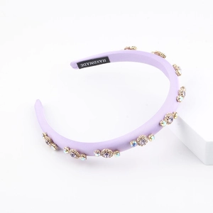 Lavender fabric headband with sparkling rhinestones and handmade woven label on white base