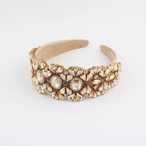 Close-up of luxury wide headband featuring champagne crystals and floral patterns