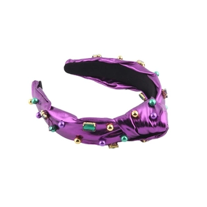 Serre-tête violet avec nœud, perles baroques et pierres précieuses sur fond blanc