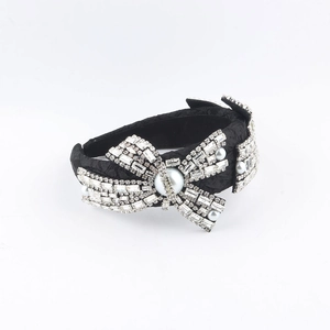 Luxurious black fabric headband with ornate crystal rhinestone bows and white pearls