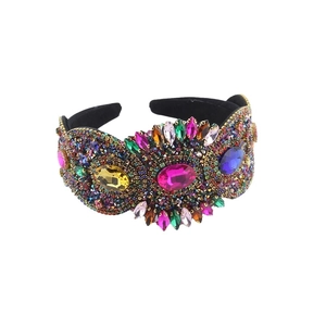 Baroque style wide headband with colorful crystals and pink center stone on black velvet
