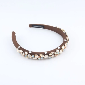 Detailed macro view of multi-color crystals and HANDMADE label on baroque headband