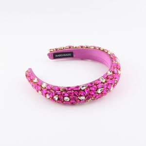 Close-up of rose pink satin baroque headband with rhinestones and handmade label