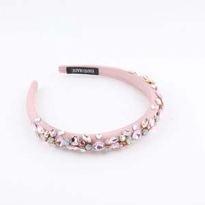Baroque style pink padded headband with colorful rhinestones and handmade label tag