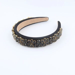 Detail view of Baroque headband with black crystal flowers and gold metal settings
