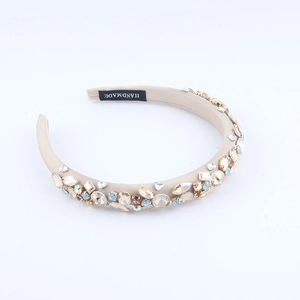 Macro shot of handmade baroque beige headband with luxury multicolor rhinestones and crystals