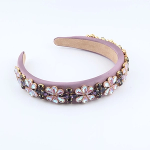 Elegant Baroque headband with purple fabric and intricate rhinestone flower embellishments