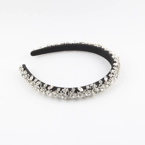 Detailed view of hand-sewn crystals and mixed rhinestones on a baroque padded headband