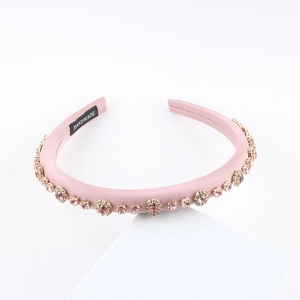 Detailed view of handmade pink leather headband with sparkling crystals and rhinestones
