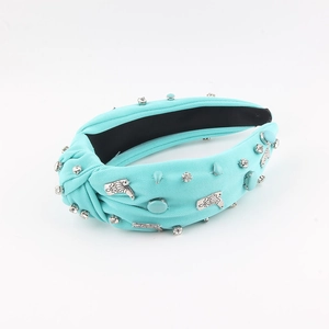 Sky blue fabric knot headband with rhinestones and silver metal accents on white background