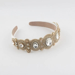 Detailed close-up of Baroque headband with sparkling crystals on gold metal frame