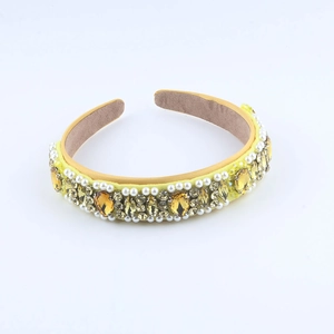 Baroque yellow fabric headband with hand-sewn crystals and pearls on white background