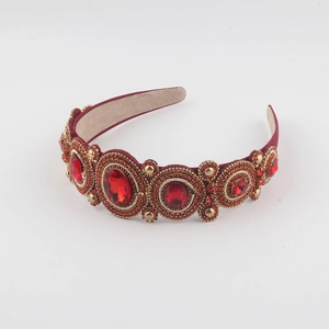 Ornate Baroque velvet headband with red crystals and golden beads in a royal vintage style