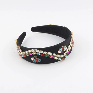 Detail of velvet padded headband with colorful rhinestones in a vintage floral pattern