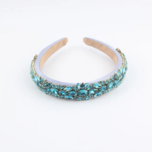 Detailed view of Baroque headband featuring blue crystals and intricate gold claw settings