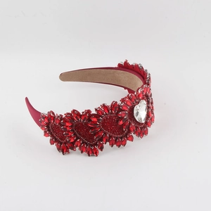 Close-up of heart-shaped headband featuring red marquise crystals and center stone