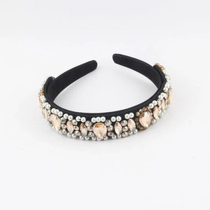 Close-up of baroque headband with champagne crystals, white pearls and rhinestones