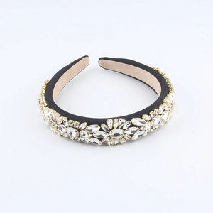 Close-up of sparkling flower pattern rhinestones and floral crystals on a slim black headband