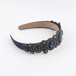 Close-up of vintage baroque headband with blue gemstones and intricate heavy beadwork details