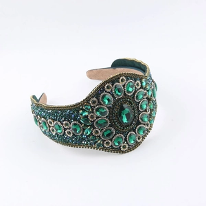 Luxury Baroque headband with emerald gemstones and crystals on golden floral pattern