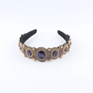Detailed view of baroque headband with purple gemstones and gold beads on black base