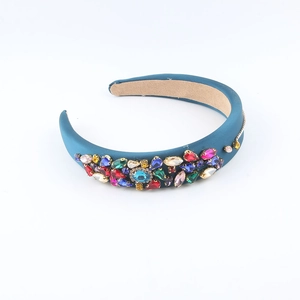 Detailed view of the wide teal satin headband with multicolored rhinestones and crystals