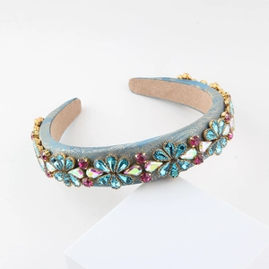 Detail of blue satin headband with floral rhinestone patterns and non-slip velvet lining