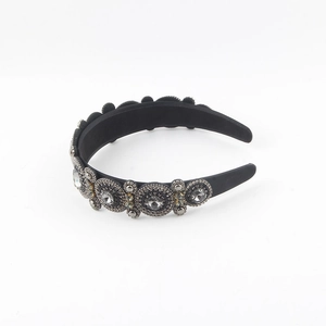Detail of baroque black wide headband featuring gray rhinestones and bead embroidery