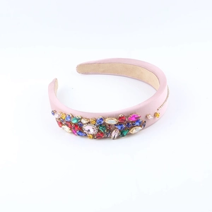 Detailed macro view of pink wide headband with multi-colored rhinestone embellishments