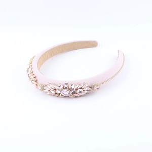 Detail of pink baroque headband featuring heavy crystal floral ornaments and velvet lining