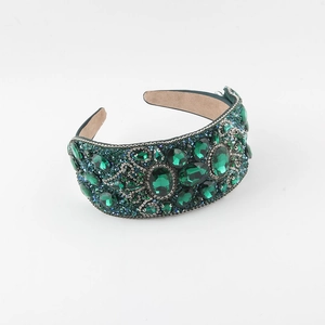 Detail of dark green Baroque headband with large rhinestones and sparkling crystals