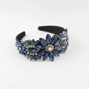 Elegant vintage dark blue crystal flower headband with white pearl detail on white background