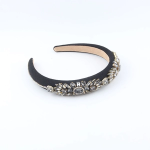 Detail of baroque headband with sparkling grey crystals and grey rhinestones on black fabric