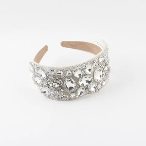 Detailed macro view of luxury baroque wide headband with densely inlaid sparkling crystals